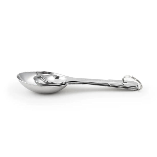 A set of stainless steel measuring spoons with a flat design, attached to a central ring, with engraved measurements on the spoons.