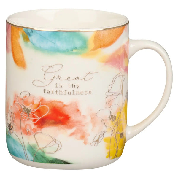 A white ceramic mug with a watercolor and floral design and the text 'Great is Thy faithfulness' printed on the side.