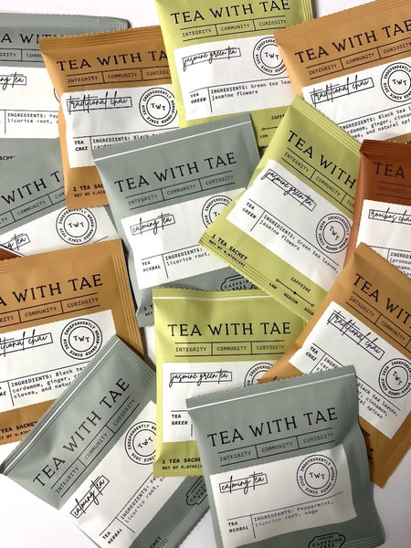 Individually wrapped tea sachets in various tea bags, each labeled with different tea varieties such as Peppermint, SPA BLISS, English Breakfast, Rooibos Chai, and Traditional Chai, displayed against a white background.