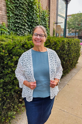 White crochet lace cardigan with 3/4 sleeves and beautiful lace design. 